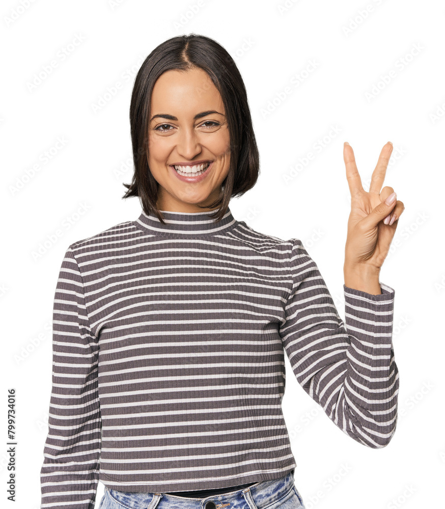 Young Caucasian woman with short hair joyful and carefree showing a peace symbol with fingers. Young Caucasian woman with short hair joyful and carefree showing a peace symbol with fingers.
