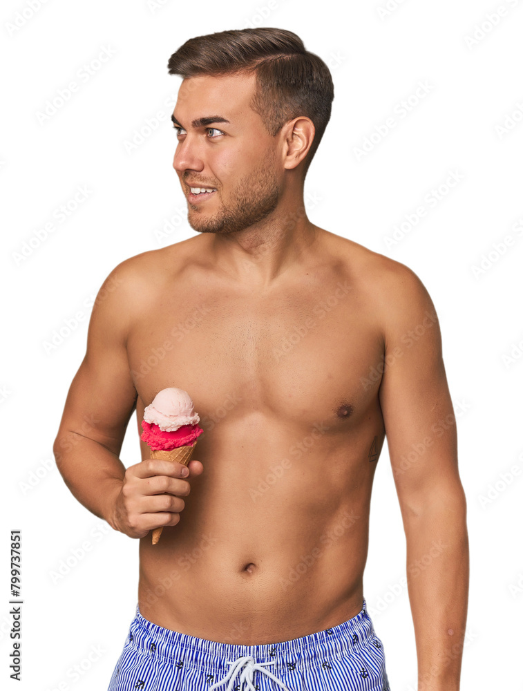 Man in swimsuit enjoying ice cream, a perfect summer indulgence Man in swimsuit enjoying ice cream, a perfect summer indulgence