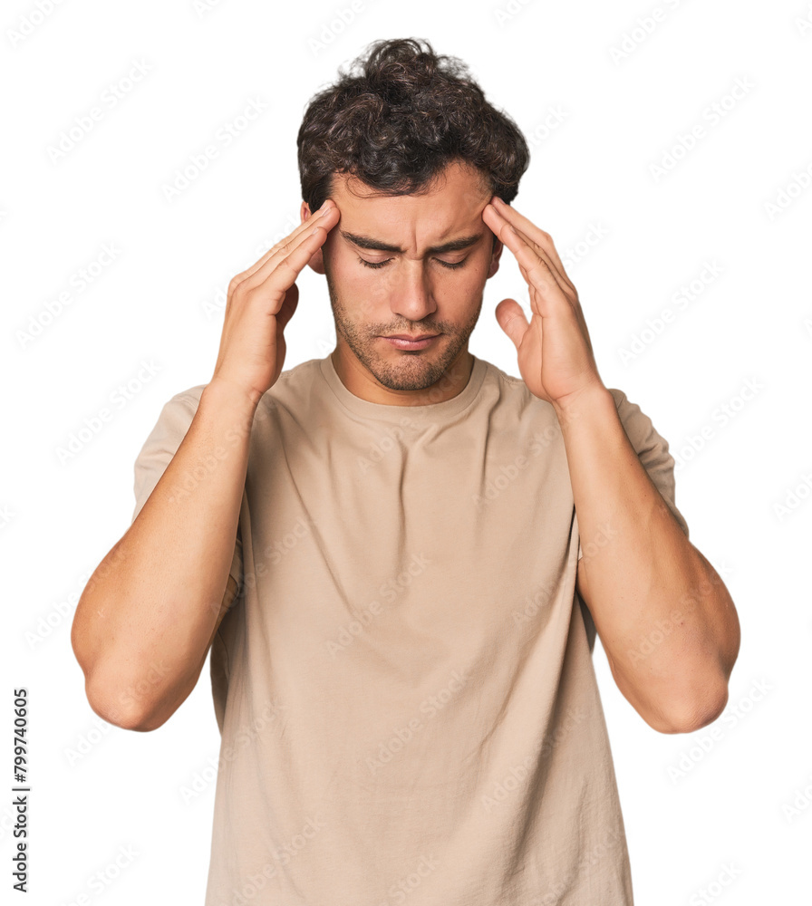Young Hispanic man in studio touching temples and having headache. Young Hispanic man in studio touching temples and having headache.