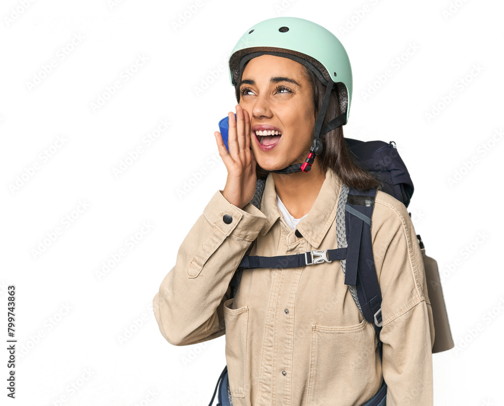 Hispanic young woman with mountain gear shouting and holding palm near opened mouth. Hispanic young woman with mountain gear shouting and holding palm near opened mouth.