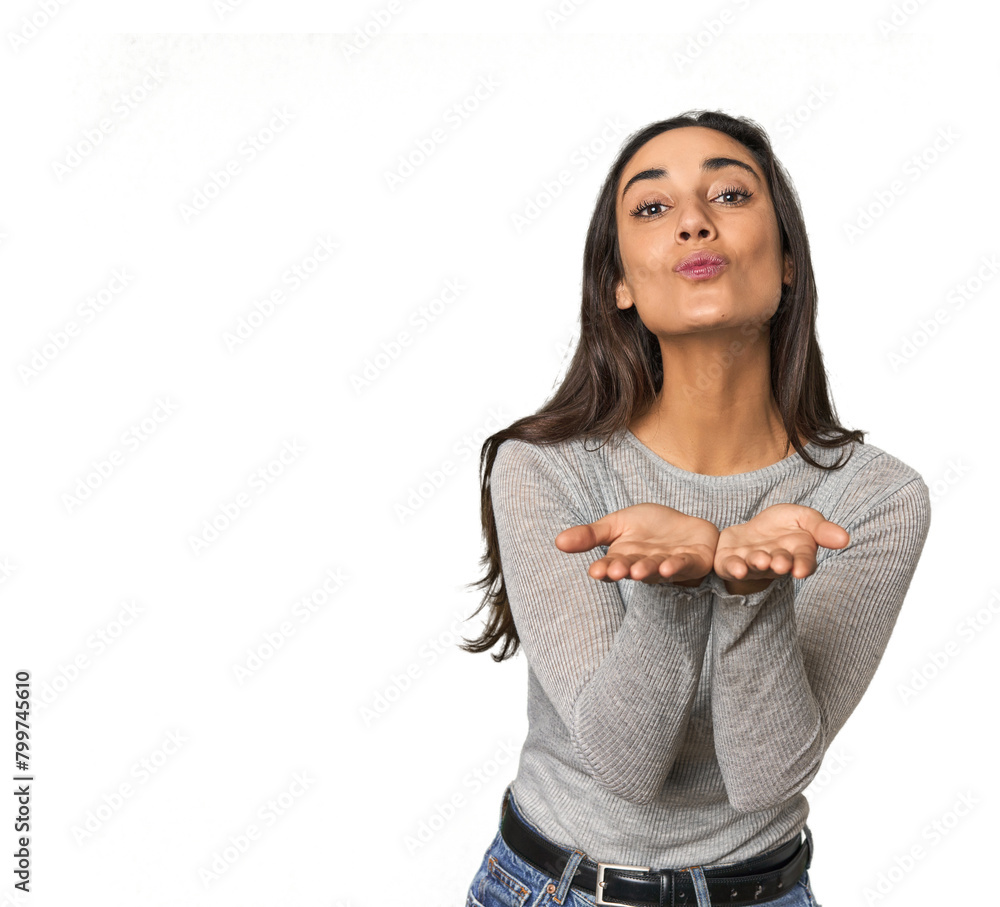Hispanic young woman folding lips and holding palms to send air kiss. Hispanic young woman folding lips and holding palms to send air kiss.