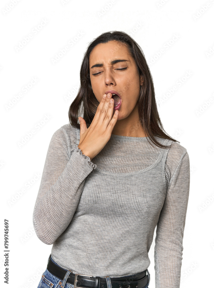 Hispanic young woman yawning showing a tired gesture covering mouth with hand. Hispanic young woman yawning showing a tired gesture covering mouth with hand.