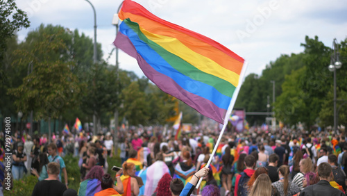 Many people wave rainbow flag. Crowd walk city street. Fun lgbt community symbol. Stop no homophobia concept. Joy pride month fest. Bi gay man go csd love day. Queer culture parade. Hold colorful sign photo