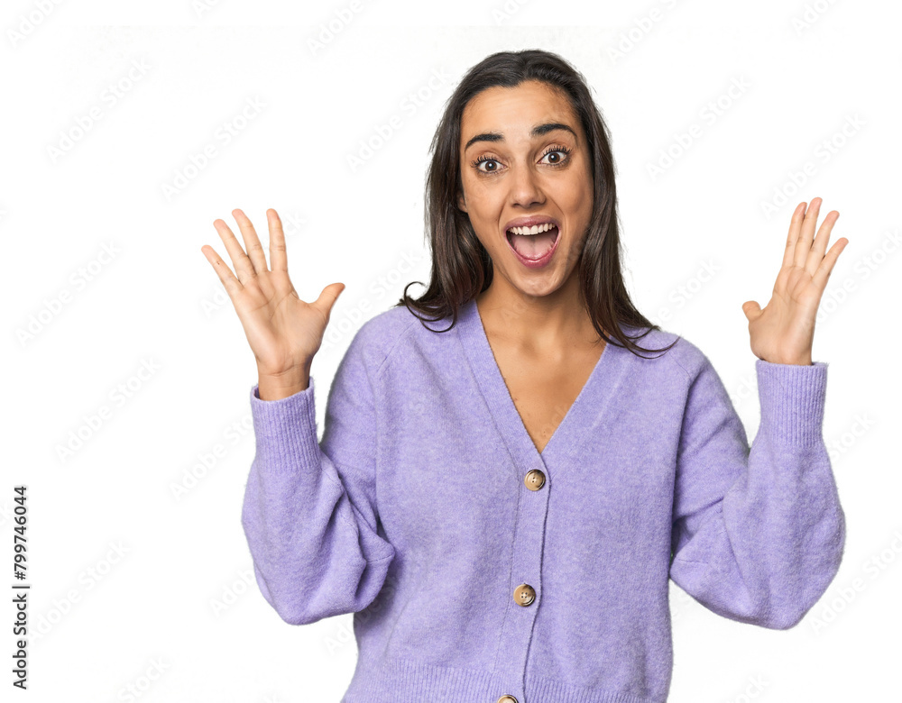 Hispanic young woman celebrating a victory or success, he is surprised and shocked. Hispanic young woman celebrating a victory or success, he is surprised and shocked.