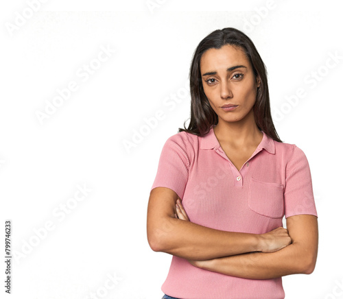 Hispanic young woman suspicious, uncertain, examining you. © Asier