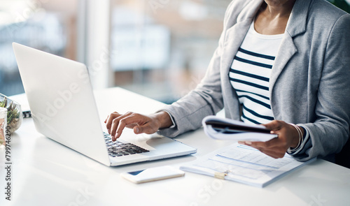 Woman, hands and laptop with documents for finance, budget planning or accounting at office. Closeup of female person, accountant or employee with paperwork for financial advice or audit at workplace