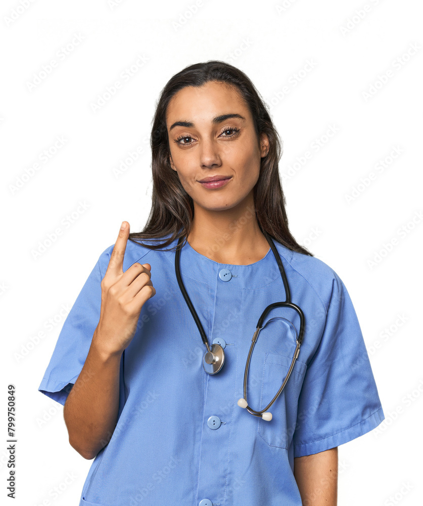 Hispanic nurse in uniform with stethoscope pointing with finger at you as if inviting come closer. Hispanic nurse in uniform with stethoscope pointing with finger at you as if inviting come closer.