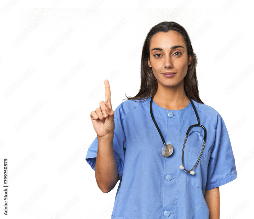 Hispanic nurse in uniform with stethoscope showing number one with finger. Hispanic nurse in uniform with stethoscope showing number one with finger.