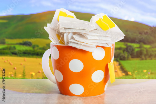Cute cup filled with tea bags. Blank labels with space for text.