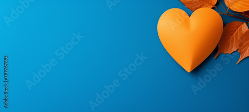 A paper heart made of red construction paper is suspended from a thin tree branch against a clear blue sky, generative AI