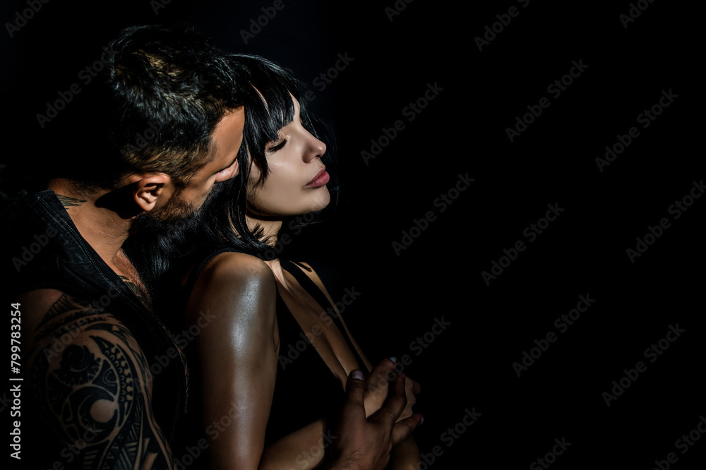 Naklejka premium Romantic sexy couple kiss. Sensual couple in love kiss. Passion, dating and love. Young beautiful sexy lovers kiss. Sensual relationship. Sexy elegant couple in the tender passion kiss.