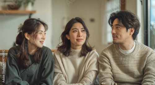 A Japanese family of three sitting on the sofa, looking at each other with expressionless faces and thinking about something, in a white living room background, in the style of Japanese photography photo