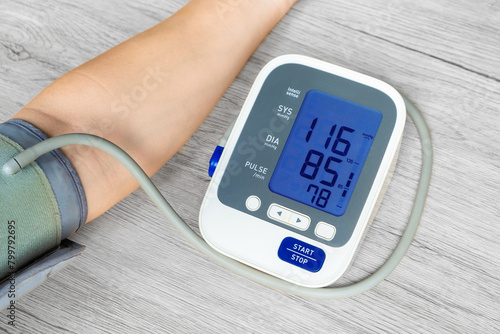 Man check blood pressure monitor and heart rate monitor with digital pressure gauge. Health care and Medical concept	