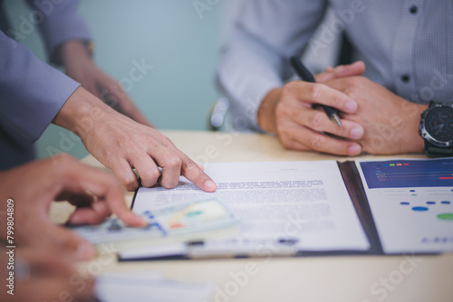 Business peoples reading documents at meeting, business partner considering contract terms before signing checking legal contract law conditions. Selected focus