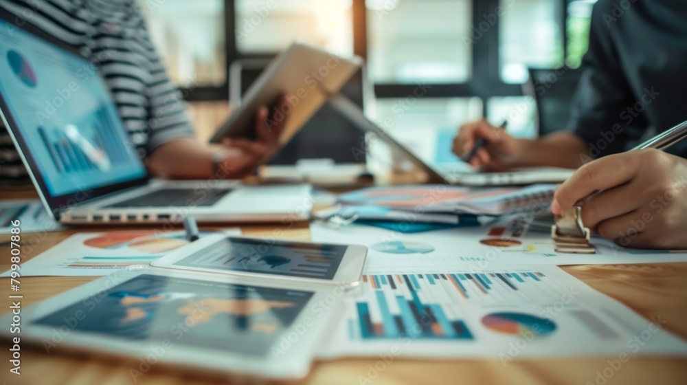 Asian businessman presenting and explaining and using laptop and tablet teamwork Financial marketing team Asian businessman presenting and explaining and using laptop and tablet teamwork Financial marketing team
