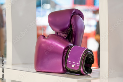 Boxing purple gloves on the shelf of the fightwear shop. Boxing gloves display at sports store. Fight shop, boxing equipment