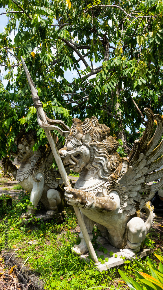 Obraz premium Bali MARCH 2024 - Stone sculpture of a beautiful winged dragon in Bali island, Indonesia. Hindu religious symbol.