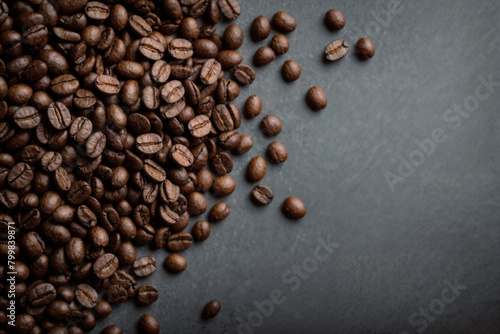 Roasted coffee beans on black background ai generated. Coffee beans macro. Top view. Generative AI.