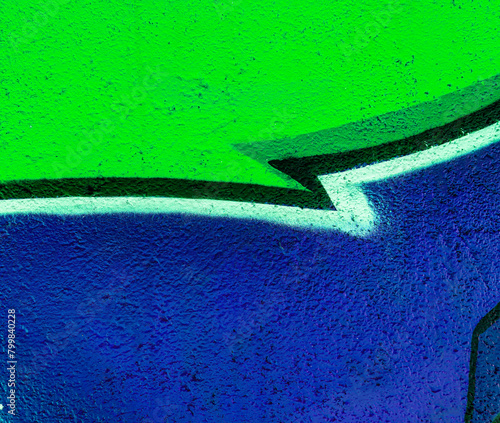 abstract and textured background of a colorful urban street wall with aerosol painted graffity pattern with concret texture