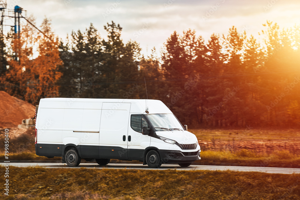 delivery van carries parcels along a sunlit road, ensuring timely service and customer satisfaction.
