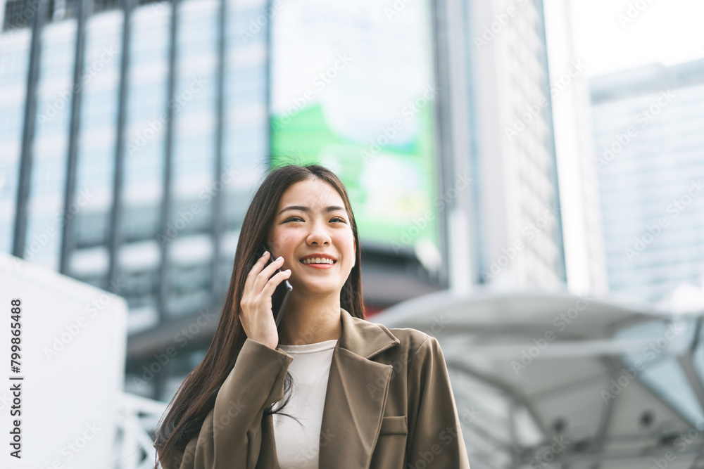 Asian business single woman using smart phone talking metropolis city background Asian business single woman using smart phone talking metropolis city background