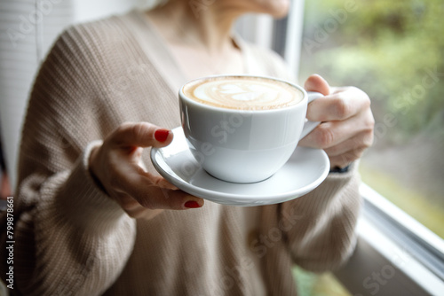 Woman holding coffee cup in hands