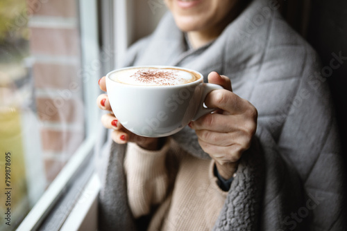 Woman holding coffee cup in hands