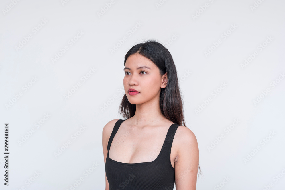 Elegant young Asian woman in black bodysuit against white background Elegant young Asian woman in black bodysuit against white background