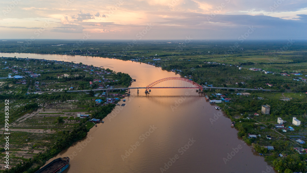Obraz premium Rumpiang Bridge in the afternoon, a bridge that stretches over the Barito river, Marabahan city, Barito Kuala district, South Kalimantan