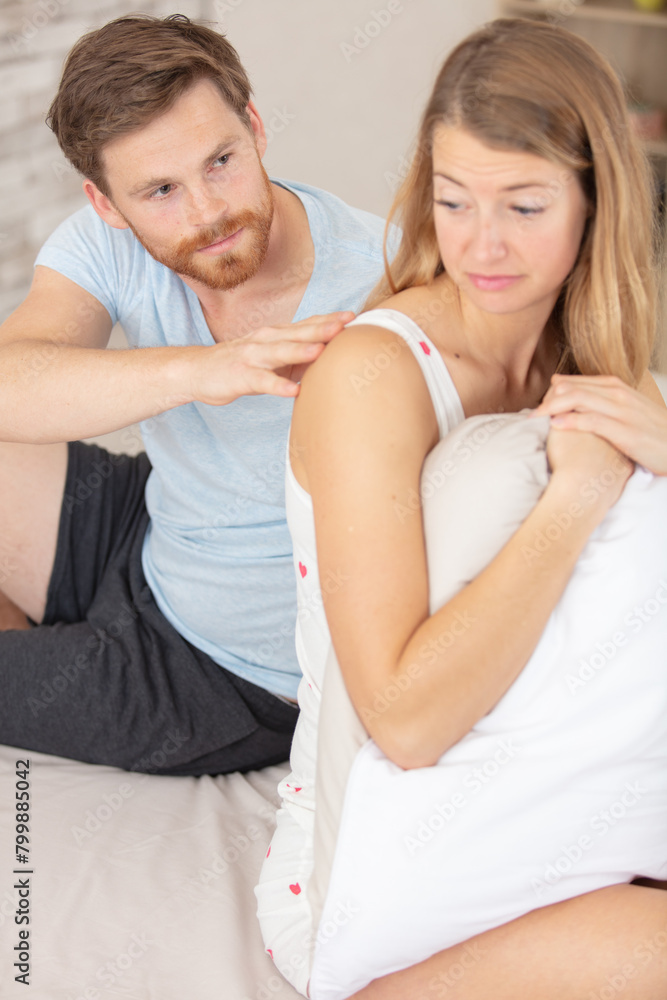 Fototapeta premium young couple having a problem laying in bed