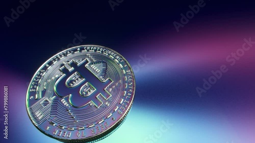 Bitcoin floats above a minimalist, colorful, clean tech surface, with a slight blur. It rotates on the surface, physically falling in accordance with gravity. High detail reveal the architecture of t (ID: 799886081)