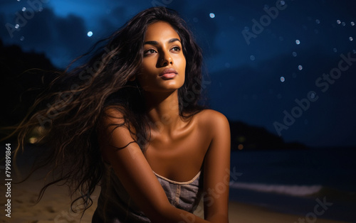 young woman looking stars on the beach