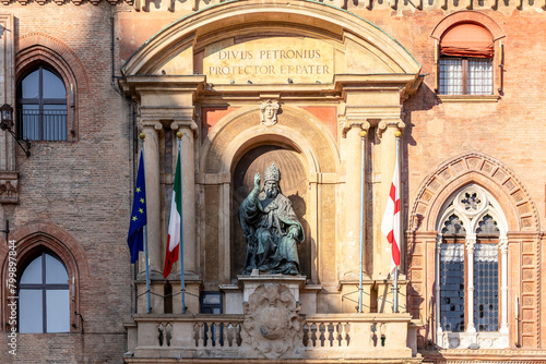 The statue of Pope Gregory XIII sits prominently on the facade of Palazzo d Accursio in Bologna  flanked by the Italian and European Union flags