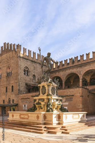 Bologna Neptune Fountain, stands in Piazza Maggiore, backed by the medieval Palazzo del Podesta (Vertical photo, no people) photo
