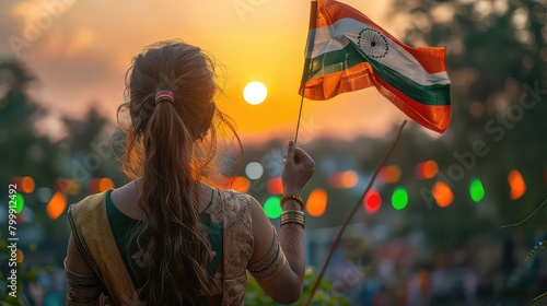 Cute little girl holding Indian flag in her hands and smiling. Celebrating Independence day or Republic day in India. Kid showing pride of Tiranga photo
