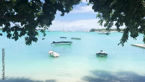 Mauritius Grand Baie is also a magnificent beach. wonderful view of the turquoise blue of the indian ocean with fishing boats on the pier. (ID: 799928299)