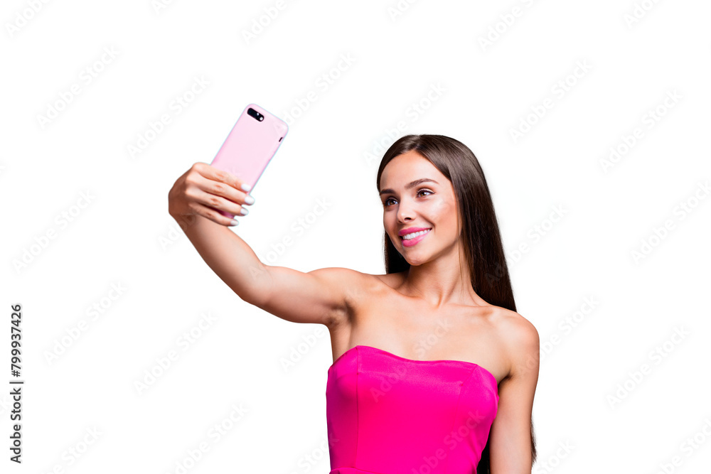 Young straight-haired sweet tender brunette smiling girl with long hair, wearing pink top, making selfie on smartphone. Isolated over bright vivid turquoise teal background Young straight-haired sweet tender brunette smiling girl with long hair, wearing pink top, making selfie on smartphone. Isolated over bright vivid turquoise teal background