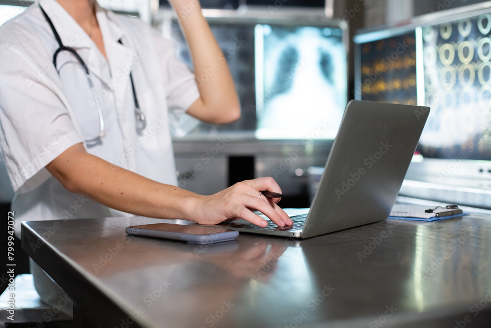 Doctor woman working with laptop check up x-ray film in medical laboratory at hospital. Anatomy diagnostic science of human. Doctor woman working with laptop check up x-ray film in medical laboratory at hospital. Anatomy diagnostic science of human.