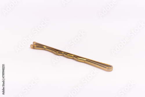 Small gold black metal hairpin isolated on white background closeup