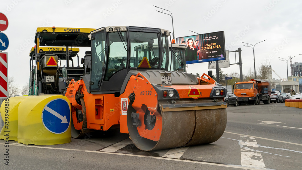 asphalt paver or roller on the road before laying asphalt