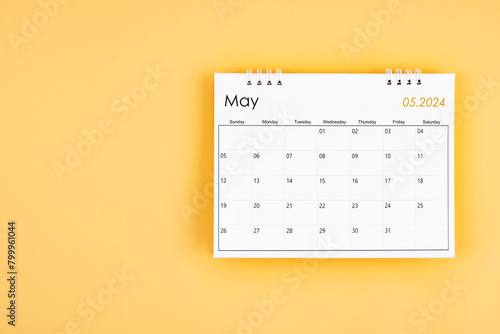 May 2024 desk calendar on yellow color background, position with copy space. © gamjai