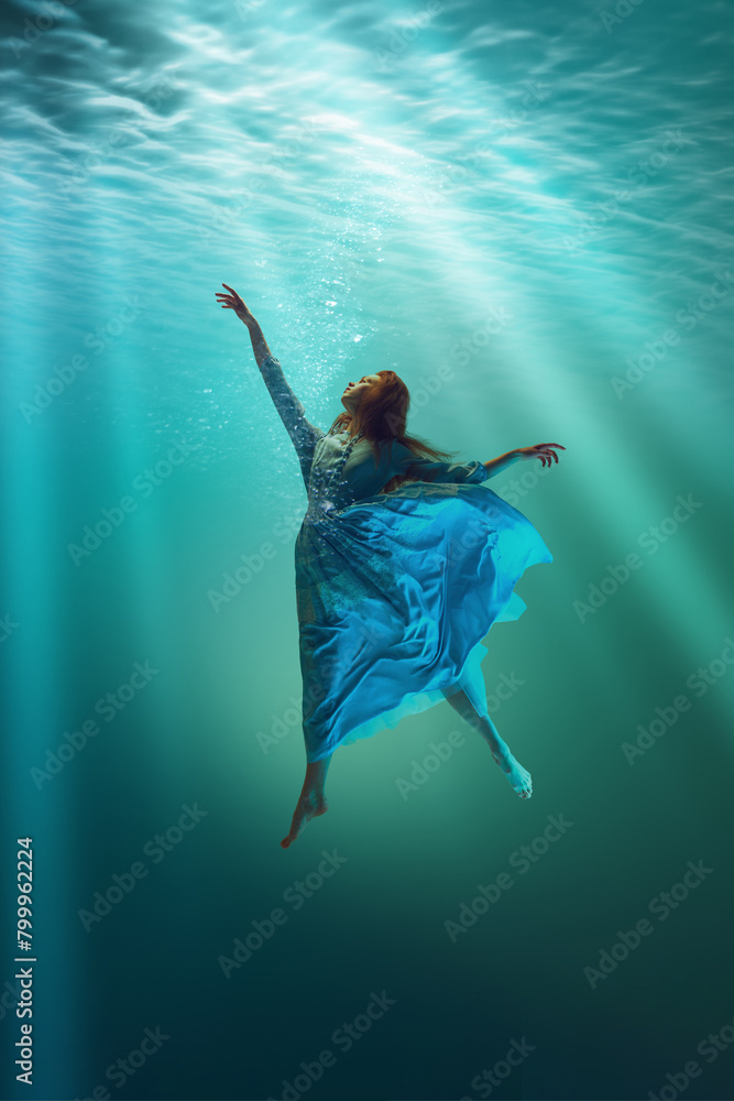 custom made wallpaper toronto digitalElegant young girl in tender blue dress immersed underwater, reaching upwards towards the shimmering light. Visual metaphor for freedom. Concept of surrealism, beauty, mystery and fantasy, freedom