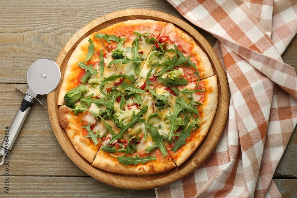 Board with delicious vegetarian pizza on wooden table, top view Board with delicious vegetarian pizza on wooden table, top view