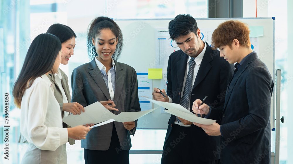 Asian group of people working with documents have financial or marketing charts on a board room at a business presentation or seminar. Asian group of people working with documents have financial or marketing charts on a board room at a business presentation or seminar.