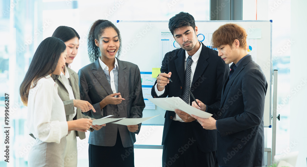 Asian group of people working with documents have financial or marketing charts on a board room at a business presentation or seminar. Asian group of people working with documents have financial or marketing charts on a board room at a business presentation or seminar.