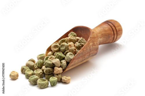 Front view of a wooden scoop filled with dry Organic Green Peas  (Pisum sativum) seeds. Isolated on a white background. photo
