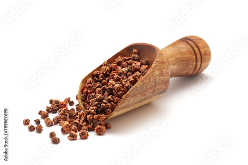 Front view of a wooden scoop filled with dry Organic Beetroot (Beta vulgaris) seeds. Isolated on a white background. photo