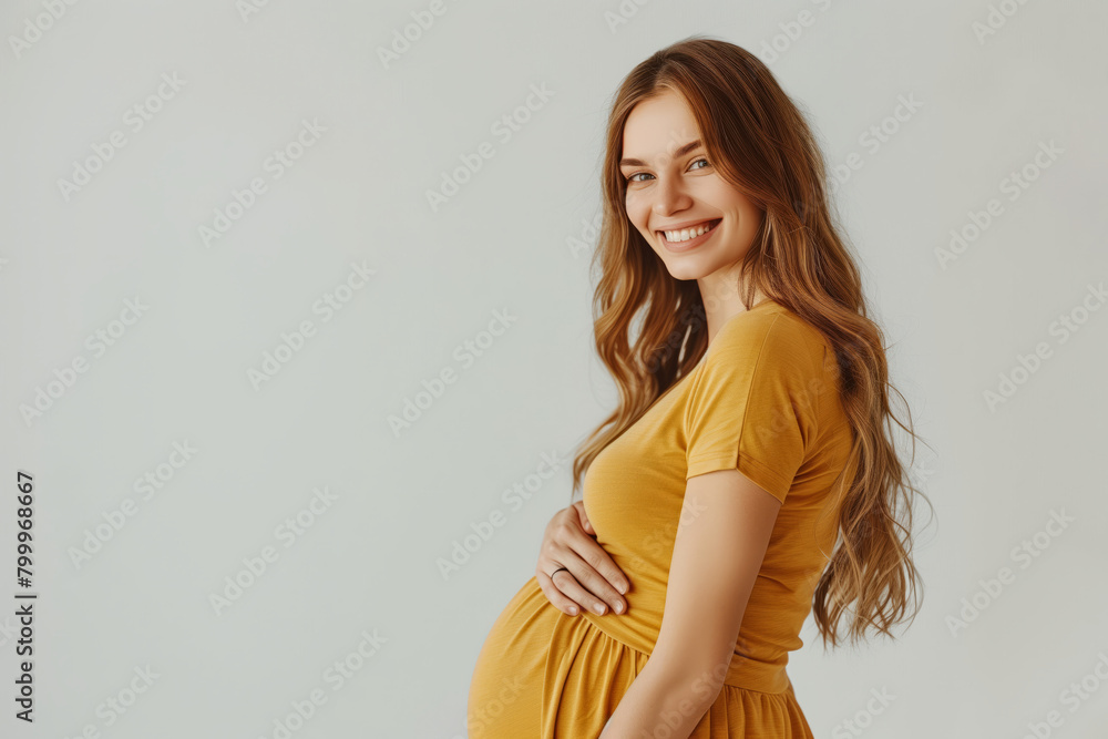 Happy pregnant woman in a yellow dress Happy pregnant woman in a yellow dress