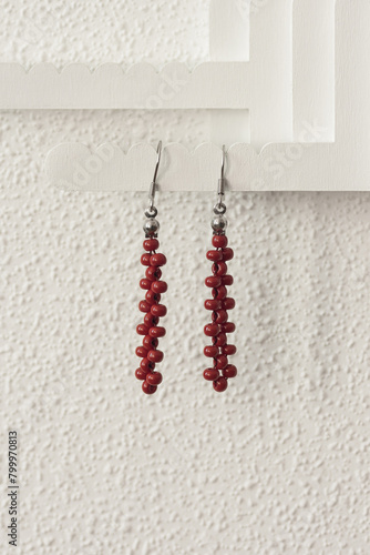 Earrings made of beads on a light background.  Close-up. DOF