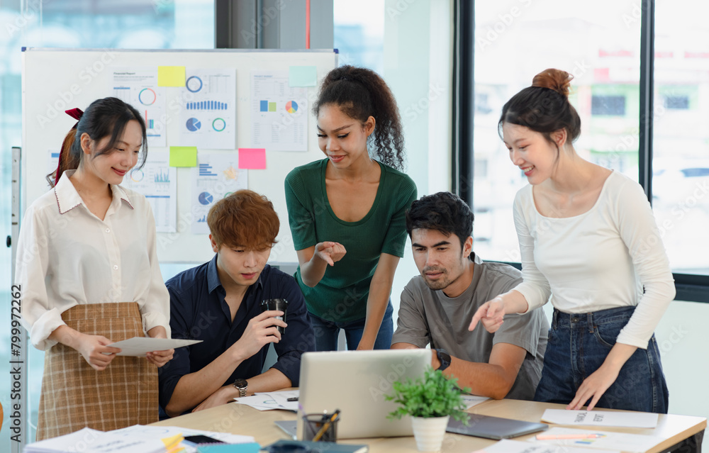 Asian group of people working with documents have financial or marketing charts on a board room table at a business presentation or seminar. Asian group of people working with documents have financial or marketing charts on a board room table at a business presentation or seminar.
